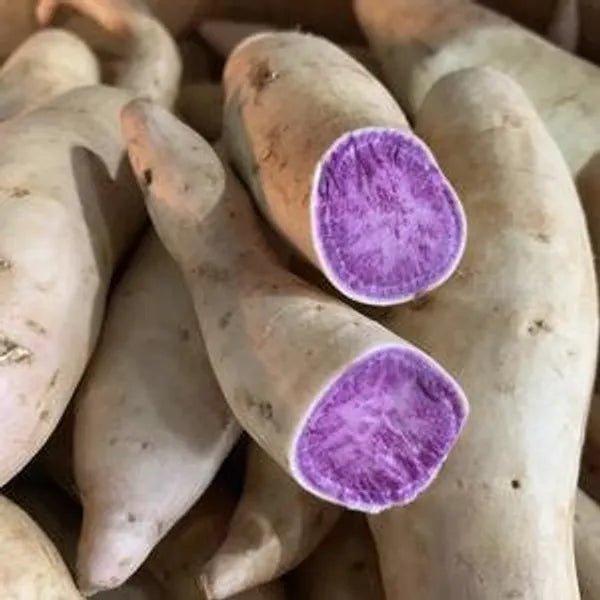 An image displaying Okinowan Sweet Potatoes that have been cut open to show their vibrant purple inside.
